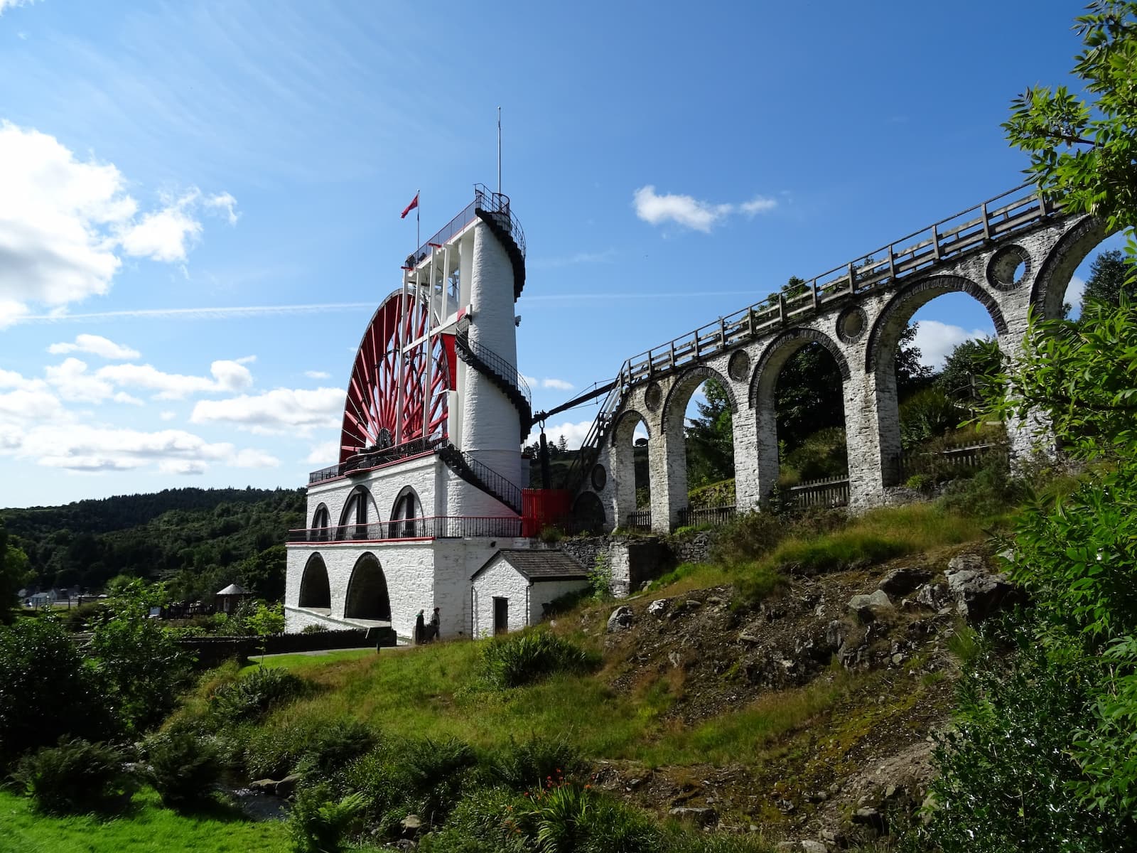 The Laxey Wheel waterwheel and its tall stone viaduct